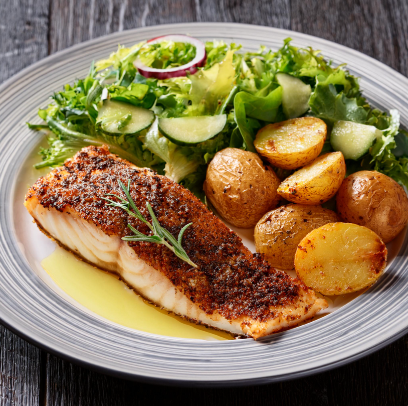 Blackened Cod on a plate with potatoes