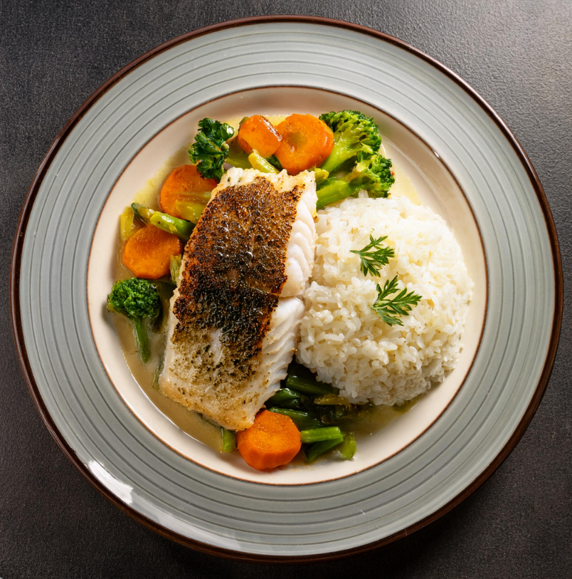 Blackened Cod on a plate with rice